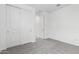 Clean bedroom showing closet with white doors, neutral carpet, and access to another room through a white door at 5011 W Hardtack Trl, Laveen, AZ 85339