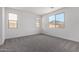 Bright, carpeted bedroom featuring three windows providing plenty of natural light at 5011 W Hardtack Trl, Laveen, AZ 85339