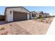 Charming home featuring a brick paver driveway, desert landscaping, and a two-car garage at 5011 W Hardtack Trl, Laveen, AZ 85339
