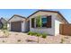 Beautiful home with desert landscaping, featuring a two-car garage and charming window shutters at 5011 W Hardtack Trl, Laveen, AZ 85339