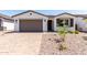 Beautiful single-story home with a brown garage door, tidy landscaping, and neutral-tone exterior paint at 5011 W Hardtack Trl, Laveen, AZ 85339