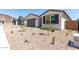 Attractive home with desert landscaping, including a two-car garage and well-maintained front yard at 5011 W Hardtack Trl, Laveen, AZ 85339