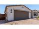 Exterior view of a two-car garage showcasing brick paver driveway and desert landscaping at 5011 W Hardtack Trl, Laveen, AZ 85339
