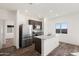 Modern kitchen featuring stainless steel appliances, granite countertops, and an island with a sink at 626 W Pintail Dr, Casa Grande, AZ 85122