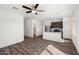 Open concept living room with hardwood floors, ceiling fan, and seamless flow into the kitchen at 626 W Pintail Dr, Casa Grande, AZ 85122