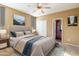 Stylized bedroom with neutral colors, a ceiling fan, a queen sized bed and attached bathroom at 7009 E Acoma, Lot #2060 Dr # 2060, Scottsdale, AZ 85254