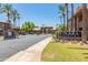 Welcoming entrance to The Plaza Residences, featuring lush landscaping, mature palm trees, and a gated entry at 7009 E Acoma, Lot #2060 Dr # 2060, Scottsdale, AZ 85254