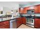 Well-lit kitchen featuring stainless steel appliances, dark countertops, and wooden cabinets at 7009 E Acoma, Lot #2060 Dr # 2060, Scottsdale, AZ 85254