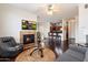 Inviting living room featuring a fireplace, dark wood floors, and a ceiling fan, perfect for relaxing and entertaining at 7009 E Acoma, Lot #2060 Dr # 2060, Scottsdale, AZ 85254