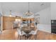 Open-concept kitchen with stainless steel appliances, wood cabinets, island, and adjacent dining area at 842 W Saragosa St, Chandler, AZ 85225