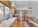Well-lit kitchen featuring stainless steel appliances, wood cabinets, and island with breakfast bar at 842 W Saragosa St, Chandler, AZ 85225