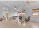 Spacious living room with neutral tones, tile floors, ceiling fans, and seating area near the windows at 842 W Saragosa St, Chandler, AZ 85225