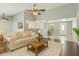 Comfortable living room with neutral colors, ceiling fan, and open floor plan to other rooms at 9716 N 55Th Ave, Glendale, AZ 85302