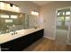 Bathroom with double sinks, a large mirror, and contemporary lighting at 1956 W Rowel Rd, Phoenix, AZ 85085