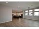 Open-concept living room flows into modern kitchen; lots of natural light from large windows at 1956 W Rowel Rd, Phoenix, AZ 85085