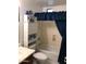 Standard bathroom with a shower-tub combination and blue shower curtains at 2638 W Sat Nam Way, Phoenix, AZ 85086