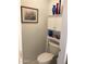 Half-bath with a decorative shelf above the toilet, and framed picture at 2638 W Sat Nam Way, Phoenix, AZ 85086