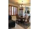 Dining area with classic wooden chairs, a curio cabinet, and views into the kitchen at 2638 W Sat Nam Way, Phoenix, AZ 85086