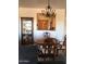 Dining area with wooden chairs and curio cabinet, with pass-through to kitchen area at 2638 W Sat Nam Way, Phoenix, AZ 85086