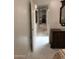 Hallway with white tile flooring leads to the kitchen with stainless appliances at 2638 W Sat Nam Way, Phoenix, AZ 85086