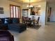 Living room with dining area featuring tile floors, shutters, and access to the kitchen at 2638 W Sat Nam Way, Phoenix, AZ 85086