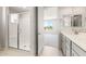 Bathroom with glass shower and dual sink vanity with an entry to a bedroom at 26995 W Adam Ave, Buckeye, AZ 85396