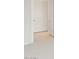 Hallway view with neutral carpet and tile transition showing door and entry to a bedroom at 26995 W Adam Ave, Buckeye, AZ 85396