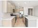 Bright, spacious kitchen featuring stainless steel appliances, neutral cabinets, and ample counter space at 26995 W Adam Ave, Buckeye, AZ 85396