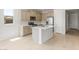 Well-appointed kitchen featuring an island, stainless steel appliances, neutral cabinets, and tile floors at 26995 W Adam Ave, Buckeye, AZ 85396