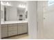 Bright bathroom with double sinks, large mirror, and tiled shower at 6247 W Georgetown Way, Florence, AZ 85132