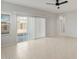 Bright living room with tiled floors, large windows, and sliding glass doors to let in ample natural light at 6247 W Georgetown Way, Florence, AZ 85132