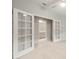 Bright office space with white French doors leading to en suite bathroom and neutral color palette at 6247 W Georgetown Way, Florence, AZ 85132