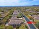 Aerial view of a community showcasing well-maintained homes, lush landscaping, and mountain views in the distance at 6827 E Eagle Feather Rd, Scottsdale, AZ 85266