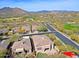 Aerial view of residential houses showcasing well-manicured landscaping, community streets, and mountain views at 6827 E Eagle Feather Rd, Scottsdale, AZ 85266