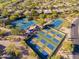 Aerial view of pickleball and tennis courts surrounded by lush desert landscaping in a vibrant community at 6827 E Eagle Feather Rd, Scottsdale, AZ 85266