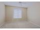 Neutral carpeted bedroom featuring window and ceiling fan at 6827 E Eagle Feather Rd, Scottsdale, AZ 85266