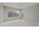 Bedroom features carpet, neutral wall color, and window with view of desert landscaping and greenery at 6827 E Eagle Feather Rd, Scottsdale, AZ 85266