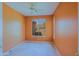 Bedroom features a ceiling fan, neutral wall colors and a window overlooking the neighborhood at 6827 E Eagle Feather Rd, Scottsdale, AZ 85266