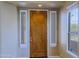 Entryway showing a wooden front door with side windows at 6827 E Eagle Feather Rd, Scottsdale, AZ 85266