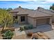 Charming single-story home with desert landscaping, tile roof, and attached two-car garage at 6827 E Eagle Feather Rd, Scottsdale, AZ 85266