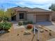 Inviting single-story home with desert landscaping, tile roof, and attached two-car garage at 6827 E Eagle Feather Rd, Scottsdale, AZ 85266