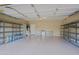 Spacious two-car garage with shelving, sink, and water heater at 6827 E Eagle Feather Rd, Scottsdale, AZ 85266