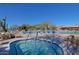 Inviting community hot tub with mountain views surrounded by pool chairs and serene desert scenery at 6827 E Eagle Feather Rd, Scottsdale, AZ 85266