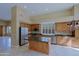 Well-equipped kitchen with stainless steel appliances, an island, and wood cabinetry at 6827 E Eagle Feather Rd, Scottsdale, AZ 85266