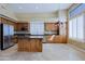 Spacious kitchen featuring wood cabinets, granite countertops, stainless steel appliances, and tile flooring at 6827 E Eagle Feather Rd, Scottsdale, AZ 85266