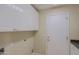 Laundry room with cabinets and access to door at 6827 E Eagle Feather Rd, Scottsdale, AZ 85266