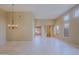 Open living room with tile floors, recessed lights, multiple windows, and a chandelier at 6827 E Eagle Feather Rd, Scottsdale, AZ 85266