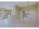 Spacious living room with tiled floors, chandelier and a doorway leading to an additional space at 6827 E Eagle Feather Rd, Scottsdale, AZ 85266