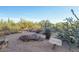 Nature path showcasing native vegetation and a rustic stone sign pointing towards Terravita Way at 6827 E Eagle Feather Rd, Scottsdale, AZ 85266