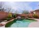 Backyard pool surrounded by lush desert landscaping at 6827 E Eagle Feather Rd, Scottsdale, AZ 85266